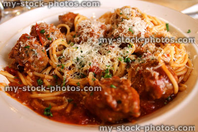 Stock image of spaghetti and meatballs with grated parmesan (close up)