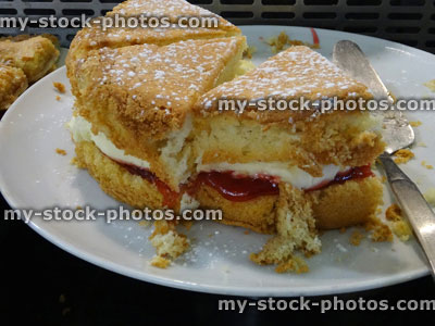 Stock image of Victoria sponge cake with strawberry jam, fresh cream, icing sugar