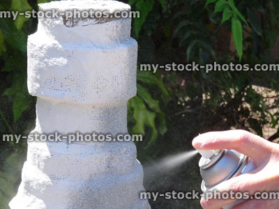 Stock image of plaster garden pillar being sprayed, granite pebble spray paint