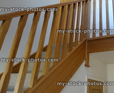 Stock image of modern, light oak stair spindles / wooden staircase balusters / balustrading