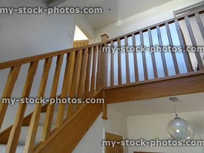 Stock image of modern, light oak stair spindles / wooden staircase balusters, hallway