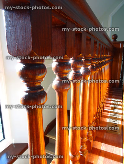 Stock image of wooden staircase spindles / stair balustrades, dark wood varnish
