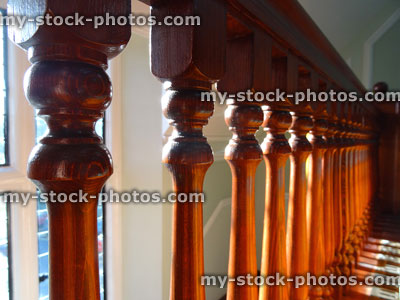 Stock image of wooden staircase spindles / stair balusters, dark wood varnish