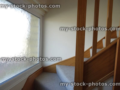 Stock image of modern, light oak stair corner, wood spindles / staircase balusters