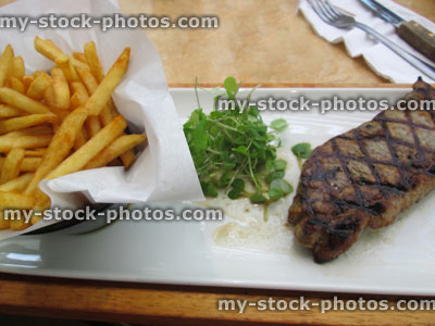 Stock image of griddled 8oz sirloin steak, watercress salad, steak and chips / frites