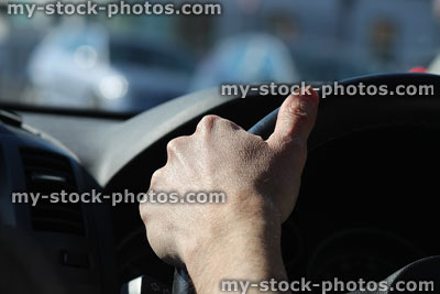 Stock image of hand holding steering wheel / dashboard, man driving car
