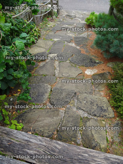 Stock image of stone steps leading to pathway in, ornamental garden stairs, stepping stones