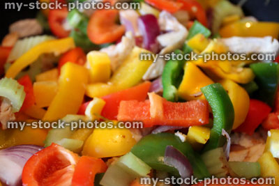 Stock image of stir fry being cooked, peppers, onions, chicken, celery