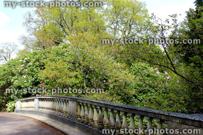 Stock image of old stone bridge in garden, with ornate balustrading