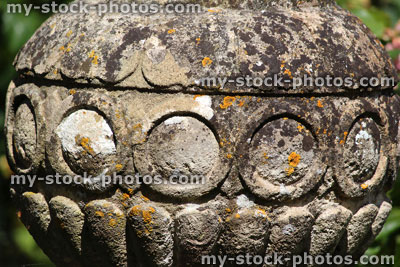 Stock image of ancient stone pot in garden, covered in lichen
