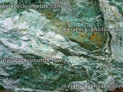 Stock image of large green marble rock, quartz veins, metamorphic rock surface