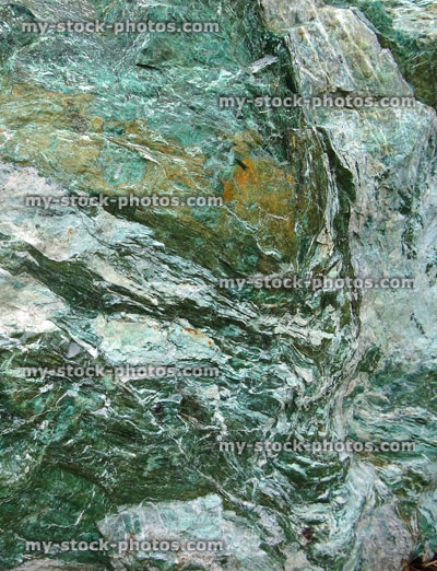 Stock image of large green marble rock, quartz veins, metamorphic rock surface