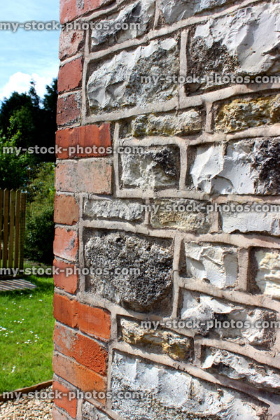 Stock image of freshly pointed brick, stone, flint wall on cottage, portrait