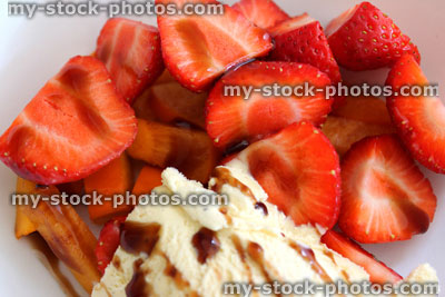 Stock image of cut strawberries with ice cream, cherry balsamic vinegar