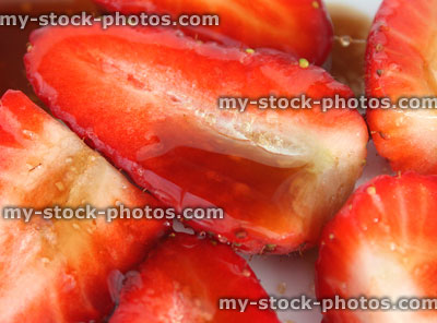 Stock image of sliced strawberries with balsamic vinegar and sugar, close up