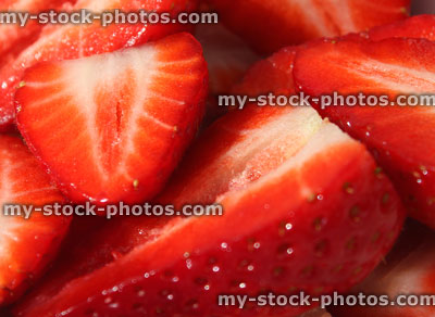 Stock image of sliced strawberry halves in dish, summer fruit / berries