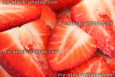 Stock image of dish of strawberry halves close up, healthy benefits, fresh summer fruit