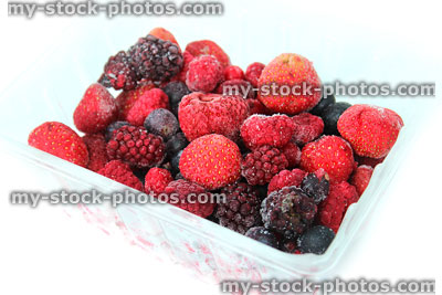 Stock image of frozen summer fruit / berries, defrosting in punnet container