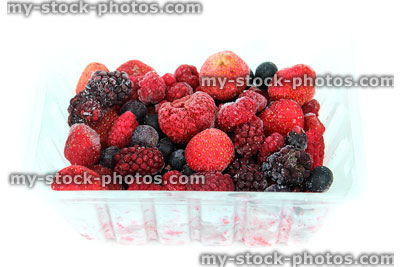 Stock image of frozen summer fruits / berries in clear plastic punnet