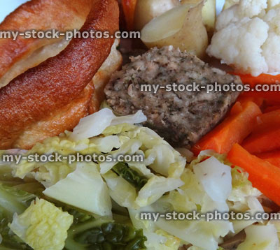 Stock image of Sunday roast dinner, beef, Yorkshire pudding, gravy, roast potatoes, vegetables, carrots peas cabbage cauliflower stuffing