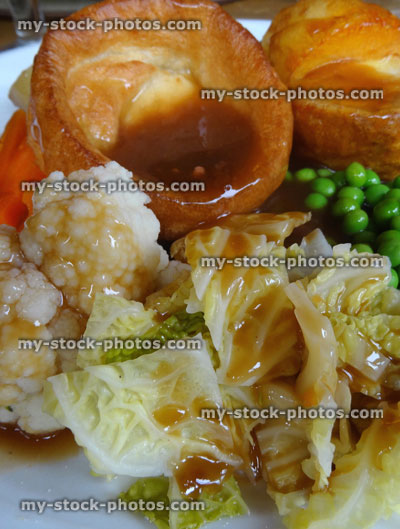 Stock image of Sunday roast dinner, beef, Yorkshire pudding, gravy, roast potatoes, vegetables, carrots peas cabbage cauliflower stuffing