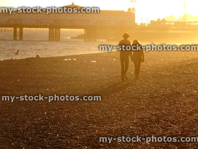 Stock image of boy / girl walking on Brighton beach at sunset