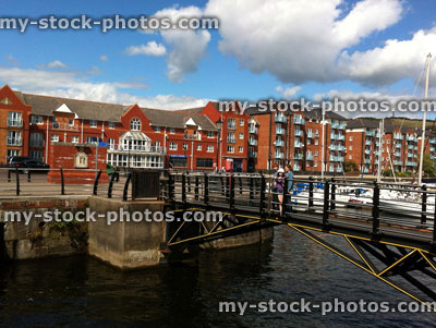 Stock image of family at Swansea marina, waterfront apartments, yachts, bridge