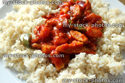 Stock image of homemade sweet and sour chicken stir fry, brown rice