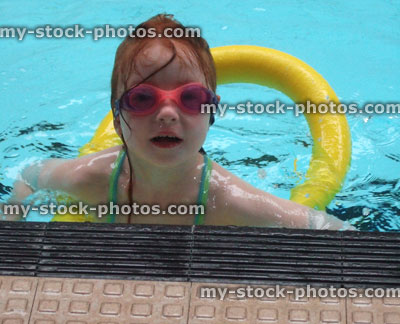 Stock image of little girl in a swimming pool