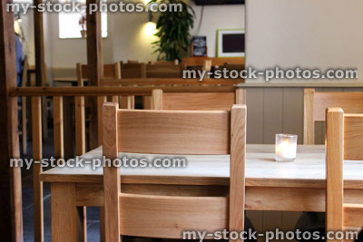 Stock image of beech wood tables and chairs ready for dinner
