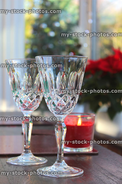 Stock image of dining table with cut crystal wine glasses, red candle