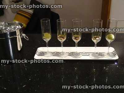 Stock image of five wine-glasses, silver wine bucket on granite counter