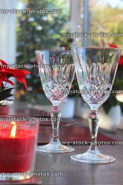 Stock image of crystal wine glasses and candle on Christmas dining table