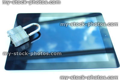 Stock image of tablet computer with padlock, sky reflections, glass screen