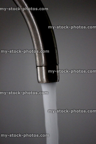 Stock image of running tap, contemporary chrome kitchen tap, running water