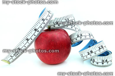 Stock image of tape measure with ripe red apple, fresh fruit
