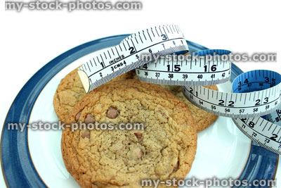 Stock image of tape measure with large homemade chocolate chip cookies