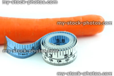 Stock image of tape measure with carrot, fresh organic carrot vegetable