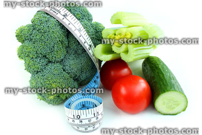 Stock image of tape measure with celery, broccoli, tomatoes, cucumber, vegetables