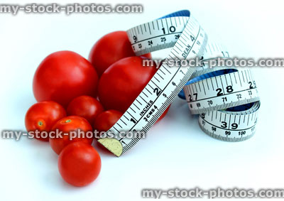 Stock image of tape measure with tomatoes, fresh organic cherry tomatoes