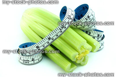 Stock image of tape measure with celery, fresh organic celery vegetable