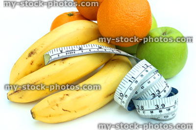 Stock image of tape measure with fruit, apple, bananas and orange