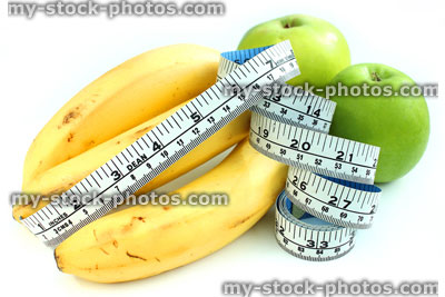 Stock image of tape measure with apples and bananas, fresh fruit