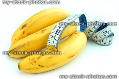 Stock image of tape measure with ripe yellow bananas, fresh fruit