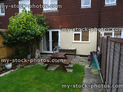 Stock image of typical 1980s terraced house with rendering / exterior wall tiles cladding / shingles, back garden