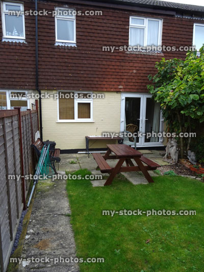 Stock image of typical 1980s terraced house with rendering / exterior wall tiles cladding / shingles, back garden