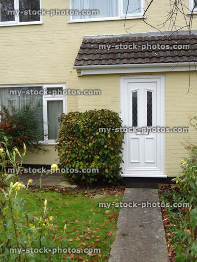 Stock image of typical 1980s terraced house, rendering (magnolia masonry paint), white upvc front door
