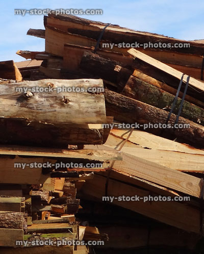 Stock image of split larch logs at lumber yard / timberyard piles
