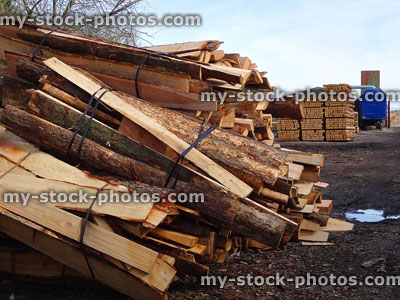 Stock image of split logs being sold as firewood bundles, bark