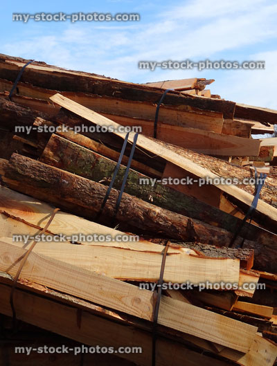 Stock image of split larch logs at lumber yard / timberyard stacks